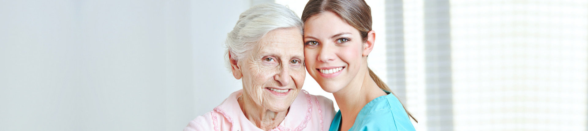 senior woman with female caregiver smiling